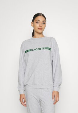 Lacoste: Серебристый топ 