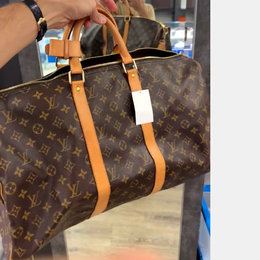 Louis Vuitton: Коричневая сумка-шоппер  Keepall 50