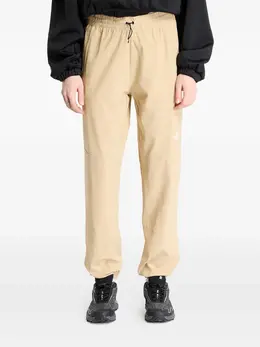 The North Face: Бежевые брюки  Wind